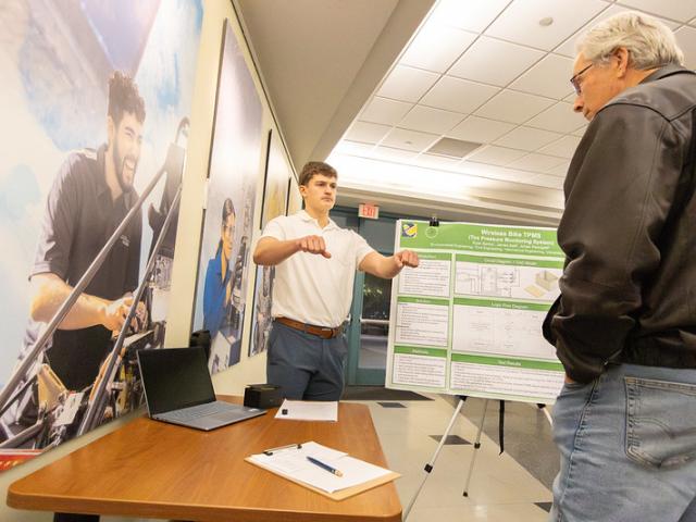 Student presenting research poster in Kemper Lobby