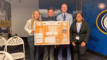 Students presenting their poster at the Midpac conference