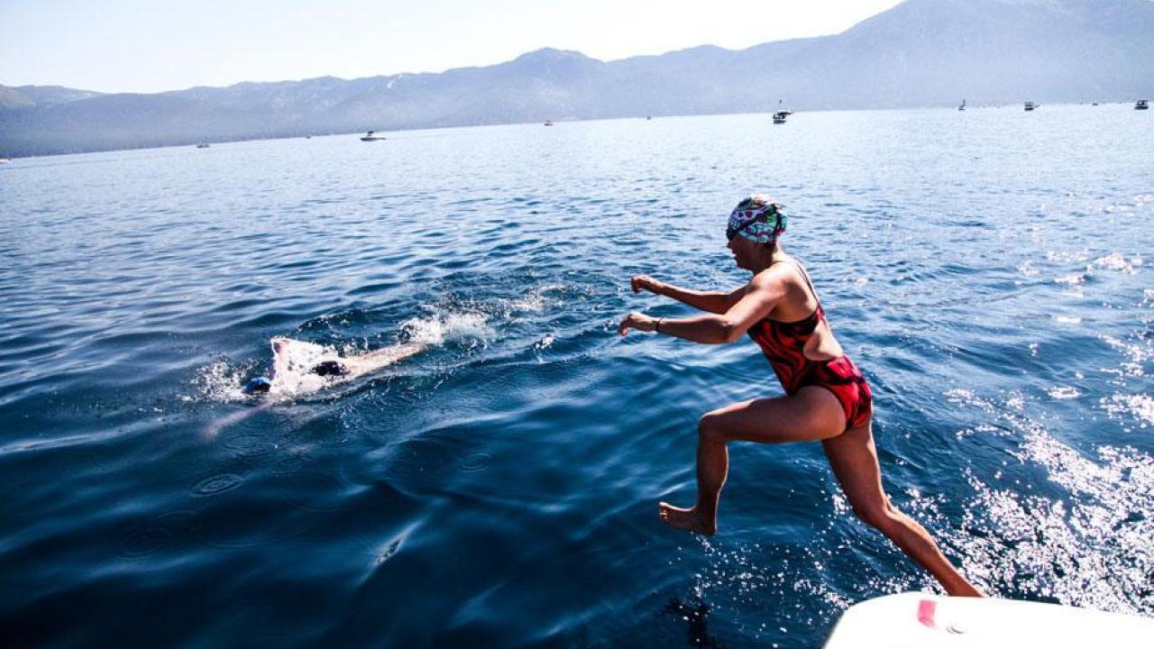 Verónica Morales, an assistant professor of civil and environmental engineering, jumps into the waters of Lake Tahoe during her first Trans Tahoe Relay in 2017. She will be be among the Aggies competing this year. (Courtesy Megan Michelson) Swimming for Science