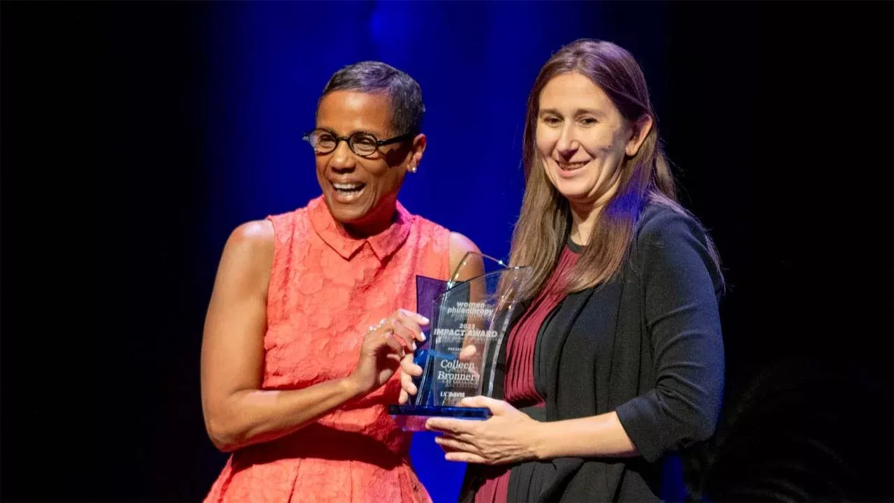 LeShelle May presents Colleen E. Bronner, associate professor of teaching, with the 2023 Women & Philanthropy Impact Award on Sunday (Nov. 5). (José Luis Villegas/UC Davis)