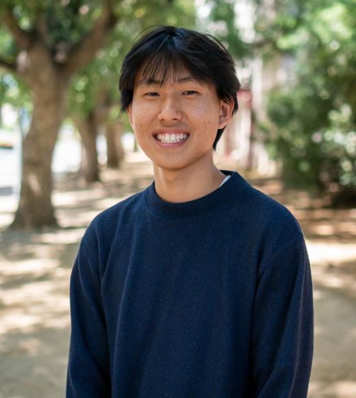 Portait shot of David, wearing a navy blue sweater.
