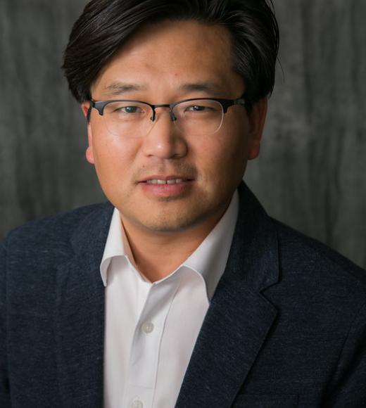 man wearing glasses and collared shirt with jacket