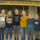 Photo of six women standing in front of the UC Davis J Amorocho Hydraulics Laboratory