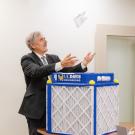 Richard Corsi presenting an air purifier with the UC Davis Engineering logo